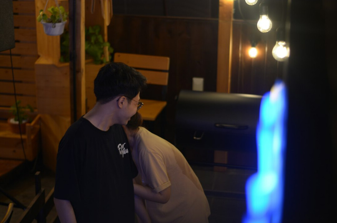 TV host calmly talking with a guest backstage before broadcast